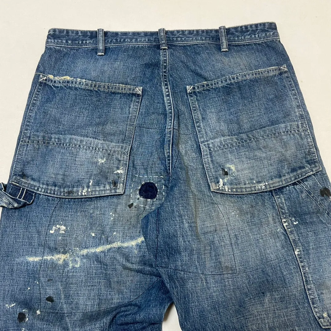 SAINT Mxxxxxx SAINT_DENIM PANTS/PAINTER /BLUE Logging trousers with knife-cut holes and splashed ink. Patch jeans. Blue S-XL. All accessories are molded and customized. Super heavy work. Washed and distressed. Knife-cut holes. Artificial splashed ink graffiti. Authentic version. Loose and stylish.